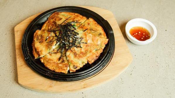 Pajeon · Traditional scallion pancake with kimchi.