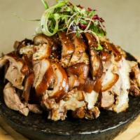 Jokbal · Pig's trotters cooked with soy sauce and spices. Comes with lettuce and Korean sauce and ser...