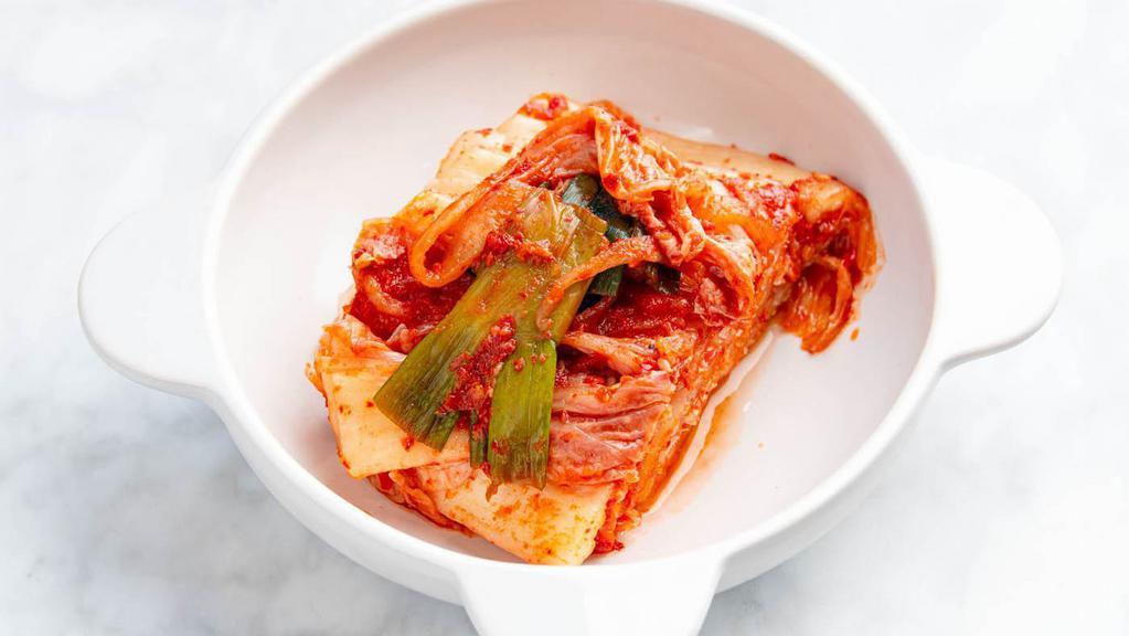 Korean Cabbage Kimchi · The most basic type of kimchi. The cabbages are cut in half and then salted or soaked in salt water. After the leaves have lost some of their water, a mixture of sliced white radish, garlic, red chili pepper powder, green onions, fish sauce, and ginger is spread over the layers of leaves.