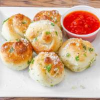 6 Garlic Knots With Sauce · Baked dough covered in garlic and parsley with a side of marinara sauce