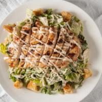 Chicken Caesar · Romaine lettuce tossed with our home made dressing, croutons and parmesan, topped with your ...