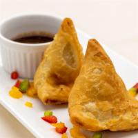 Vegetable Samosa · Mildly spiced potatoes, peas, stuffed in a light pastry wrap.