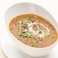 Dal Makhani · Slow cooked black lentils tempered with curry leaves and spices.