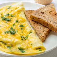 Cheese Omelette · Fluffy omelette with melty cheese. Served with home fries & golden, buttered toast.