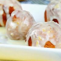 Lemon Zeppoles · The perfect size Italian doughnuts drizzled with a sweet lemon glaze and dusted with powdere...