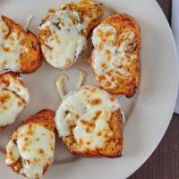 Garlic Bread Parm  · Half a dozen slices of Garlic Bread with melted cheese on top.