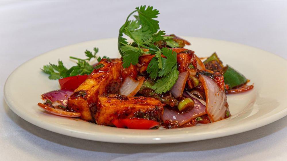 Paneer Chili Dry · Strips of cottage cheese tossed with spicy chili, onions, green pepper and soy.