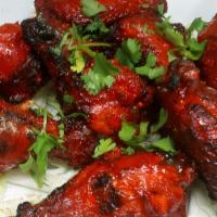 Tandoori Spicy Chicken Wings · Marinated in yogurt and spices and roasted in the clay oven.