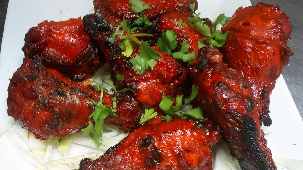 Tandoori Spicy Chicken Wings · Marinated in yogurt and spices and roasted in the clay oven.