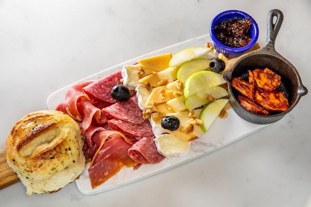 Charcuterie Board · Special Selection of Spanish and Italian Cured Meats, Brie and Creamy Smoked Gouda Cheese.