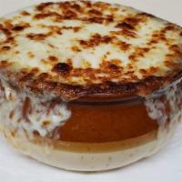 French Onion Soup · Topped with a layer of melted mozzarella and swiss cheese.
