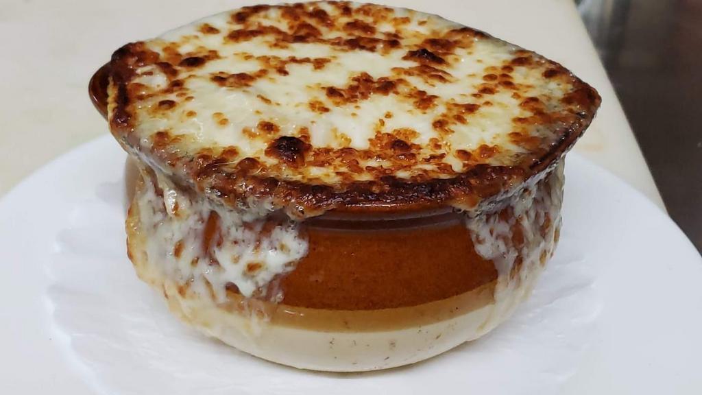 French Onion Soup · Topped with a layer of melted mozzarella and swiss cheese.