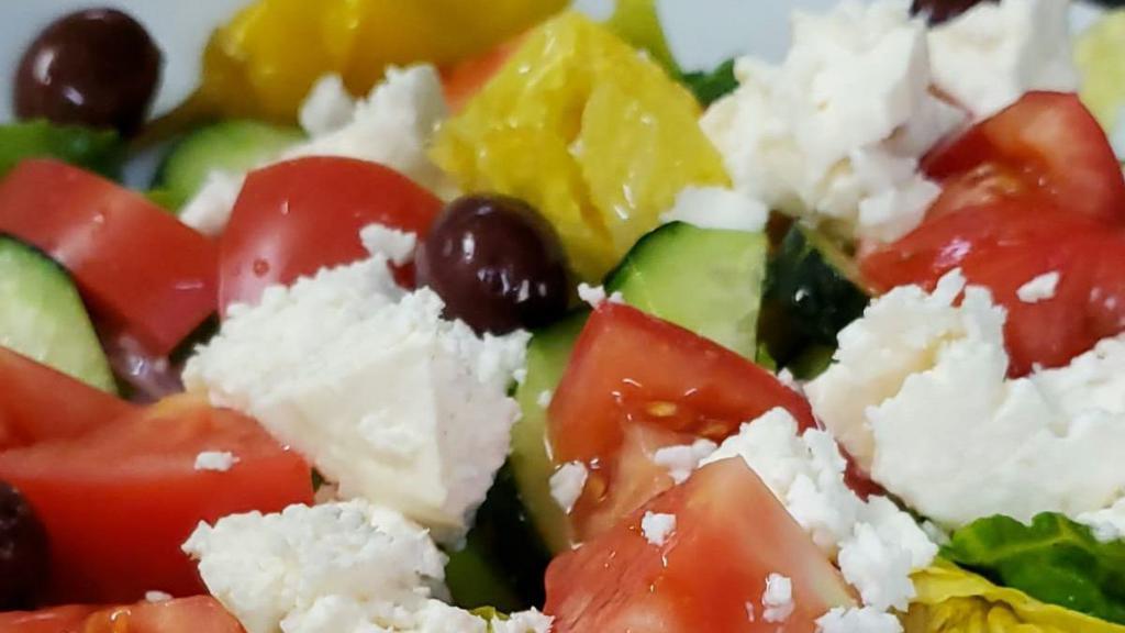 Greek Salad · Romaine lettuce, red onion, feta cheese, tomatoes, cucumbers, pepperoncini peppers, kalamata olives, with a lemon oil dressing.