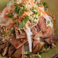 Bun Thit Nuong · marinated slices of grilled pork chop served with shredded leaves and cucumber and ground pe...