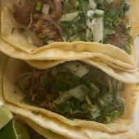 Lengua (Cow Tongue) Taco · Served with cilantro, onions and lime wedges.