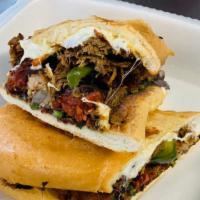 Torta Hot And Sweet · Chicken, pineapple, onions, cilantro, jalapeños and hot sauce. Served with oaxaca cheese, bl...