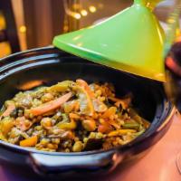 Moroccan Tagine · lamb or eggplant, Israeli couscous, chickpeas, spices, slow-cooked in our clay Tagine pot.