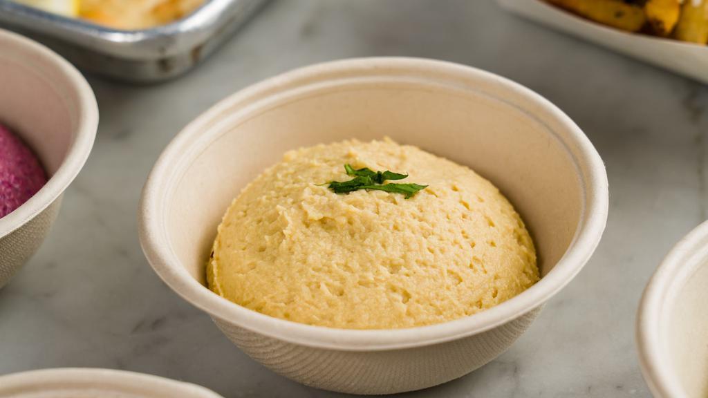Hummus · Fresh chickpea tahini with lemon and extra virgin olive oil. Served with warm pita bread.