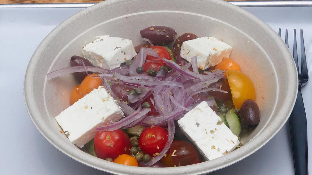 Greek Salad · Fresh seasonal tomatoes, cucumbers, onions, capers, Kalamata olives and feta with extra virgin olive oil and red wine vinegar.