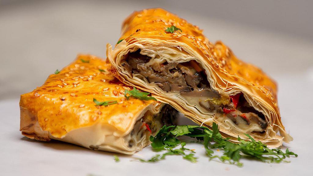 Mushroom Pie · Fresh mushrooms, peppers and Kasseri Cheese wrapped in a flaky fillo crust