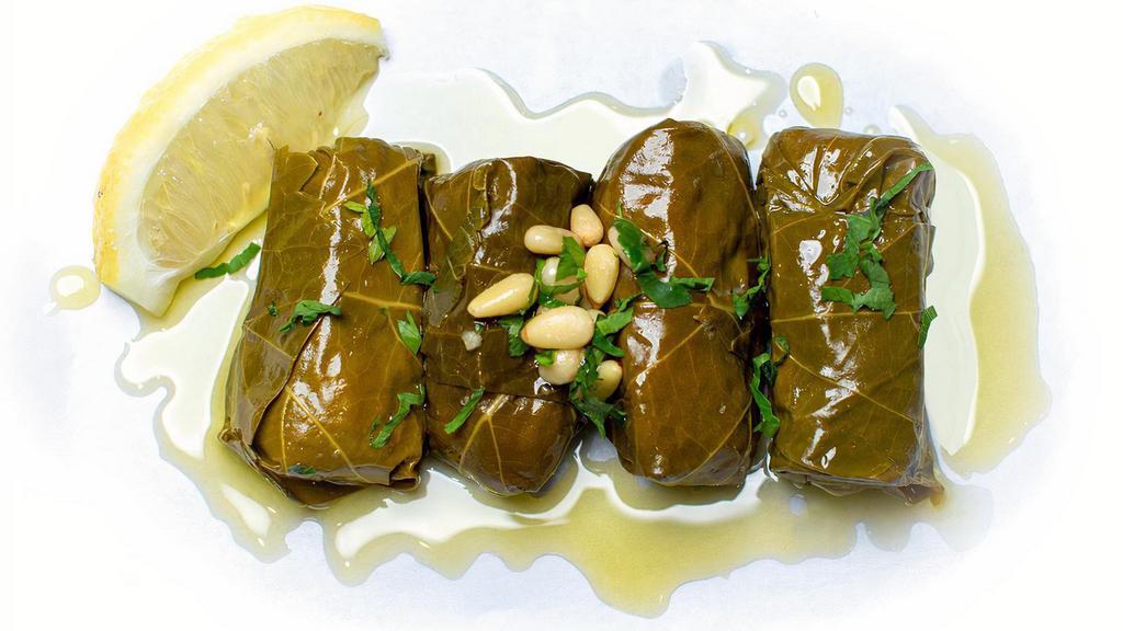 Dolmades (4 Pc) · Hand rolled grape leaves stuffed with rice, currant, golden raisins, pine nuts and herbs served with lemon yogurt dipping sauce