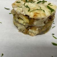 Artichoke Mousaka (Meatless) · FRESH ARTICHOKE HEARTS, LAYERED WITH CARAMELIZED ONIONS, HERBS AND GREEK CHEESE BECHAMEL SAUCE