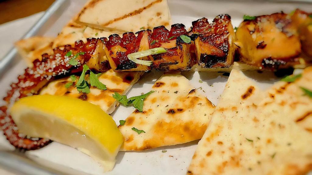 Octopus Skewer · Deliciously grilled tender leg, served with lemon wedge and a pita