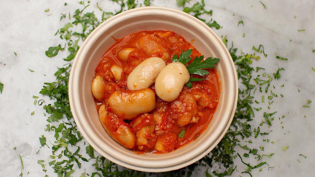 Gigandes · Greek giant beans baked in aromatic tomato sauce with honey and dill