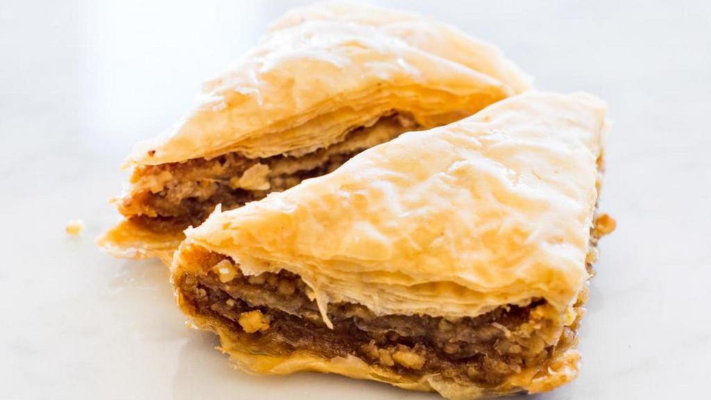 Baklava · Layered fillo pastry with chopped walnuts and sweet honey. Topped with toasted pistachio.