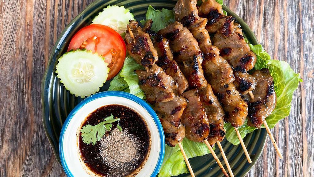 Moo Ping / หมูปิ้ง · Grilled marinated pork on a stick served with spicy homemade sauce.