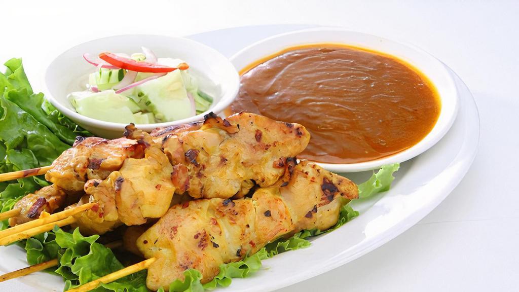 Chicken Satay / ไก่สะเต๊ะ · Marinated chicken skewers served with peanut sauce cucumber sauce and roasted bread.