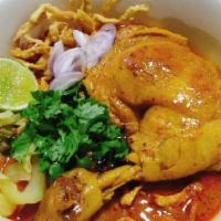 Khao Soi Noodle / ข้าวซอย · Egg noodles with chicken legs in creamy coconut yellow curry soup, scallion, red onion, pick...