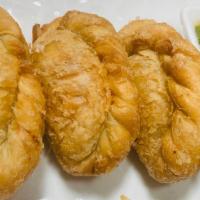 Fried Curry Puff · Fried vegetable curry puffs served with homemade house sauce.