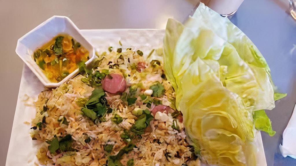 Nam Khao (Crispy Rice) · Crispy fried rice with fermented pork sausage, lime juice with Lao seasonings, garlic, scallion cilantro mixed. Served with lettuce and house sauce.