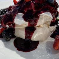 Meringue Pavlova · With berries and cream.