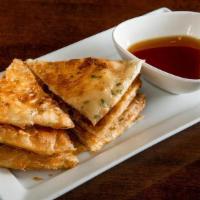 Scallion Pancake' · Not Spicy. Scallion pancake cut into eight pieces. Served w/ ginger soy sauce.