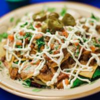 Nachos · Chicken or steak. Tortillas chips, re-fried pinto beans, sour cream, pico de gallo, cotija c...