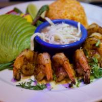 Camarones A La Parrilla · Grilled shrimp seasoned with panchito’s sauce with mix greens salad, avocado, mango slices, ...