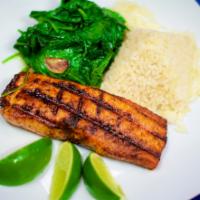 Salmon A La Parrilla · Grilled salmon filet, served with white rice and sautéed spinach.