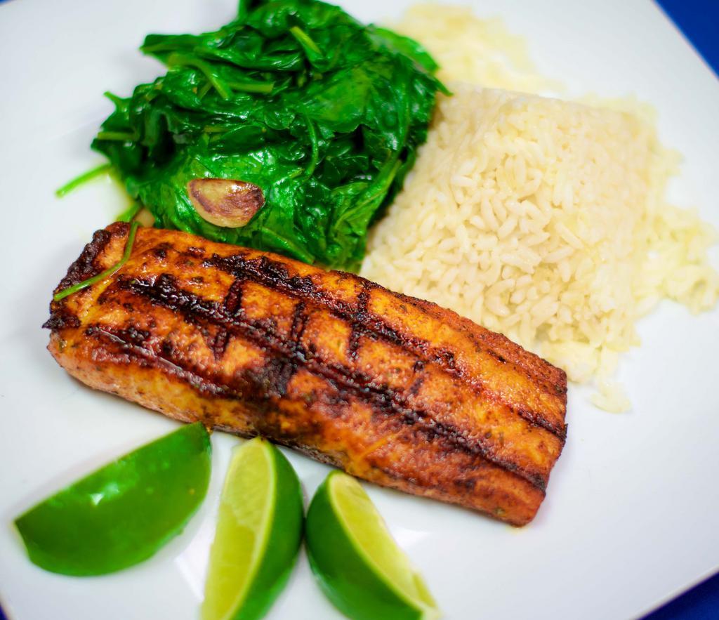 Salmon A La Parrilla · Grilled salmon filet, served with white rice and sautéed spinach.
