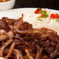 Bistek Encebollado/ Steak Onion · Mexican thin steak served with caramelized onions.