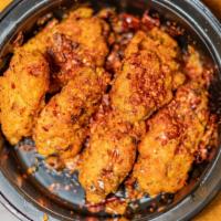 Dry Pepper Chicken Wings · Six dry rubbed chicken wings stir-fried with dry chili pepper, long hot peppers, Sichuan pep...