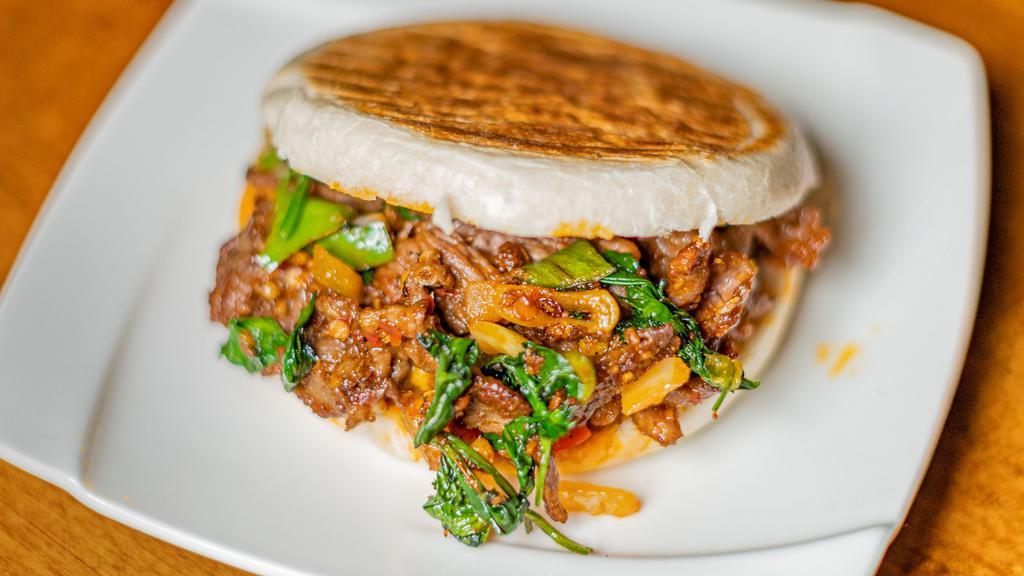 Cumin Lamb Burger · Sichuan cumin seasoned sliced lamb, with bell peppers and onions on Chinese bun