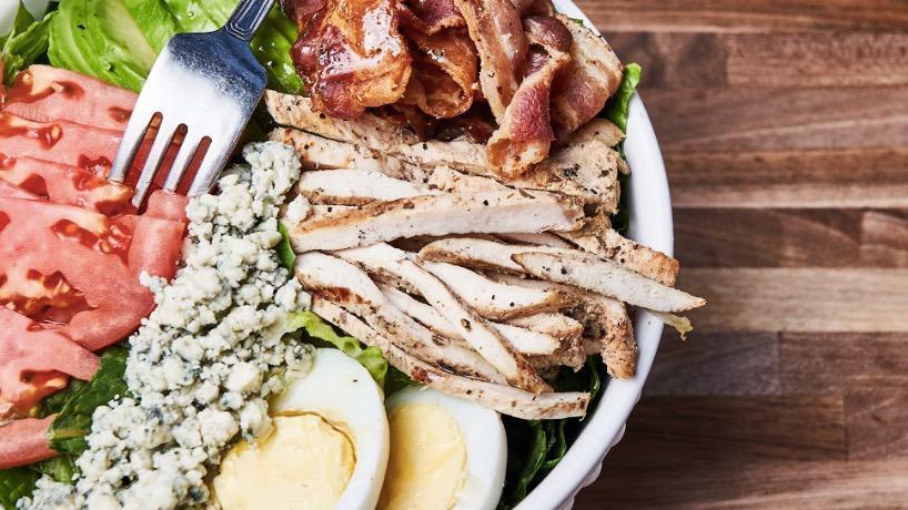 Cobb Salad · Grilled chicken, avocado, bacon crumbles, hard boiled egg,. tomatoes, crumbled blue cheese.