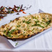 Garlic Naan · Tandoori naan topped off with garlic and cilantro.