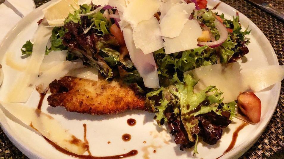 Milanese · Thin Breaded Breast Topped With Baby Arugula, Tomatoes, Onions and Balsamic Vinaigrette, Shaved Parmigiana.