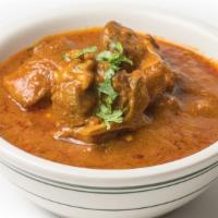 Goat Curry With Bone · Tender goat cooked with onions and curry sauce.