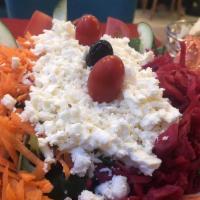 Mediterranean Salad · Mediterranean salad with lettuce, carrots, red cabbage, cucumber, tomatoes and feta cheese.