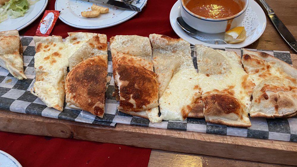 Cheese Pide · A thick dough crust stuffed with choice of feta cheese or Turkish kashar cheese.
