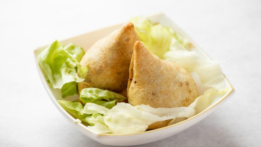 Samosa · Fried pastry stuffed with a savory filling of spiced potatoes and peas.